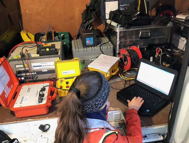 Joanna Holmgren setting up equipment to run the DAS, hydrophones and impulsive source from the van. Image courtesy of Bristol University.